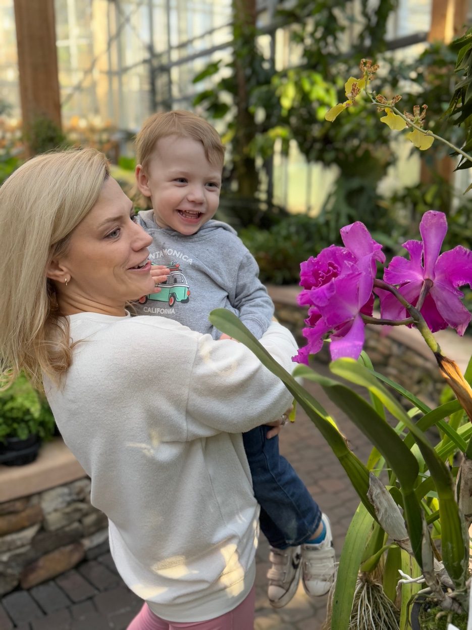 Jenny and Austin exploring orchids at the greenhouse